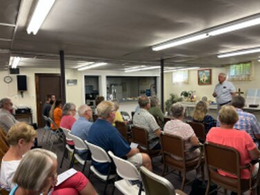 Here we are, gathered downstairs, receiving the Word.