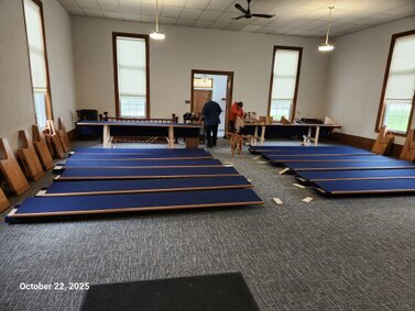 The pews are getting laid out.<br /><br />The 2 men in the back are the installers.  Both were good men.